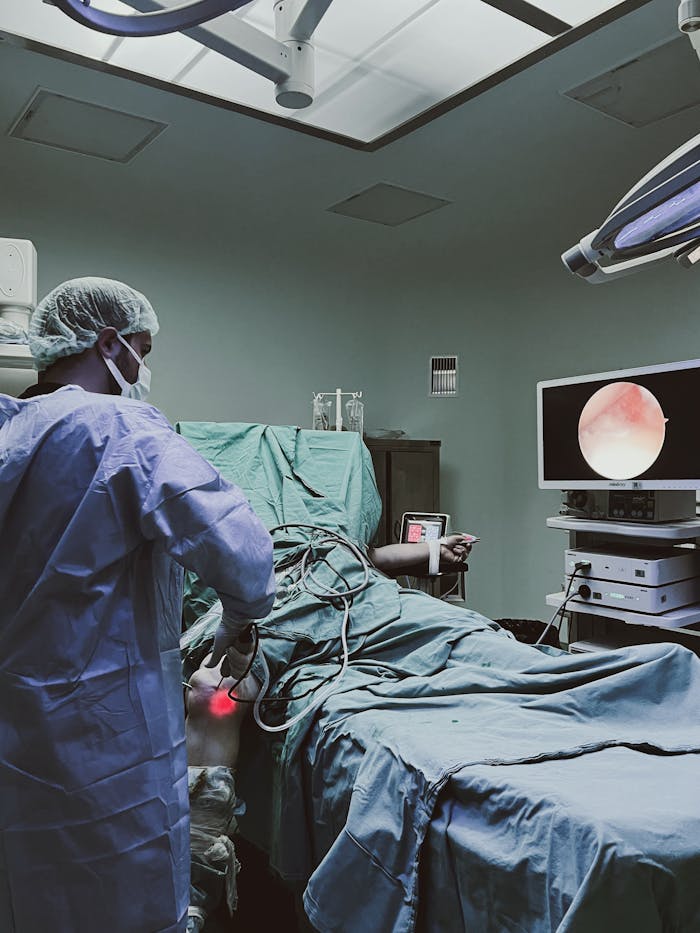 A surgeon performs laparoscopic surgery in a modern operating room, ensuring precision and care.